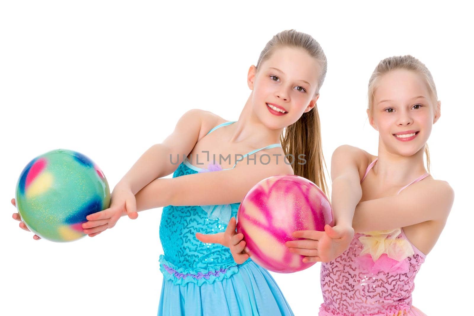 Girls gymnasts perform exercises with the ball. by kolesnikov_studio