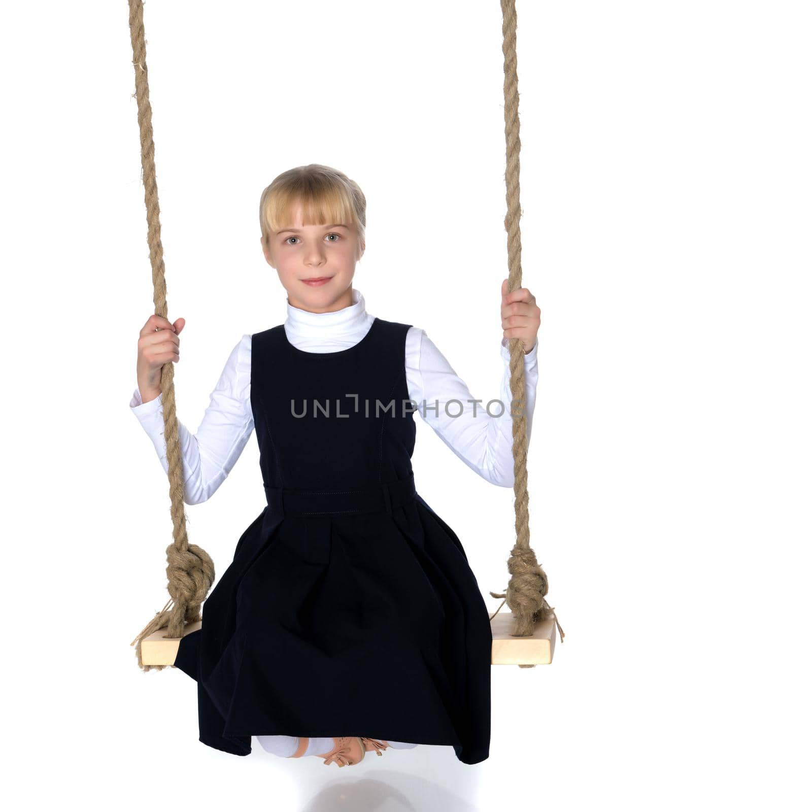 Beautiful little girl swinging on a swing. The concept of family happiness, summer holidays. Isolated on white background.