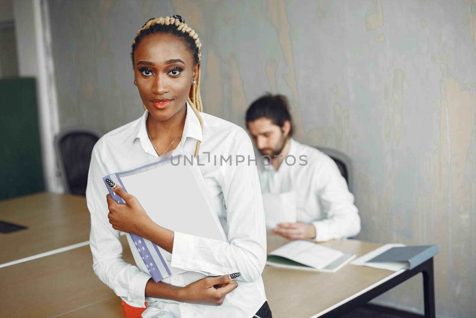 Handsome man in a white shirt. African woman with partner. Guy with a laptop.