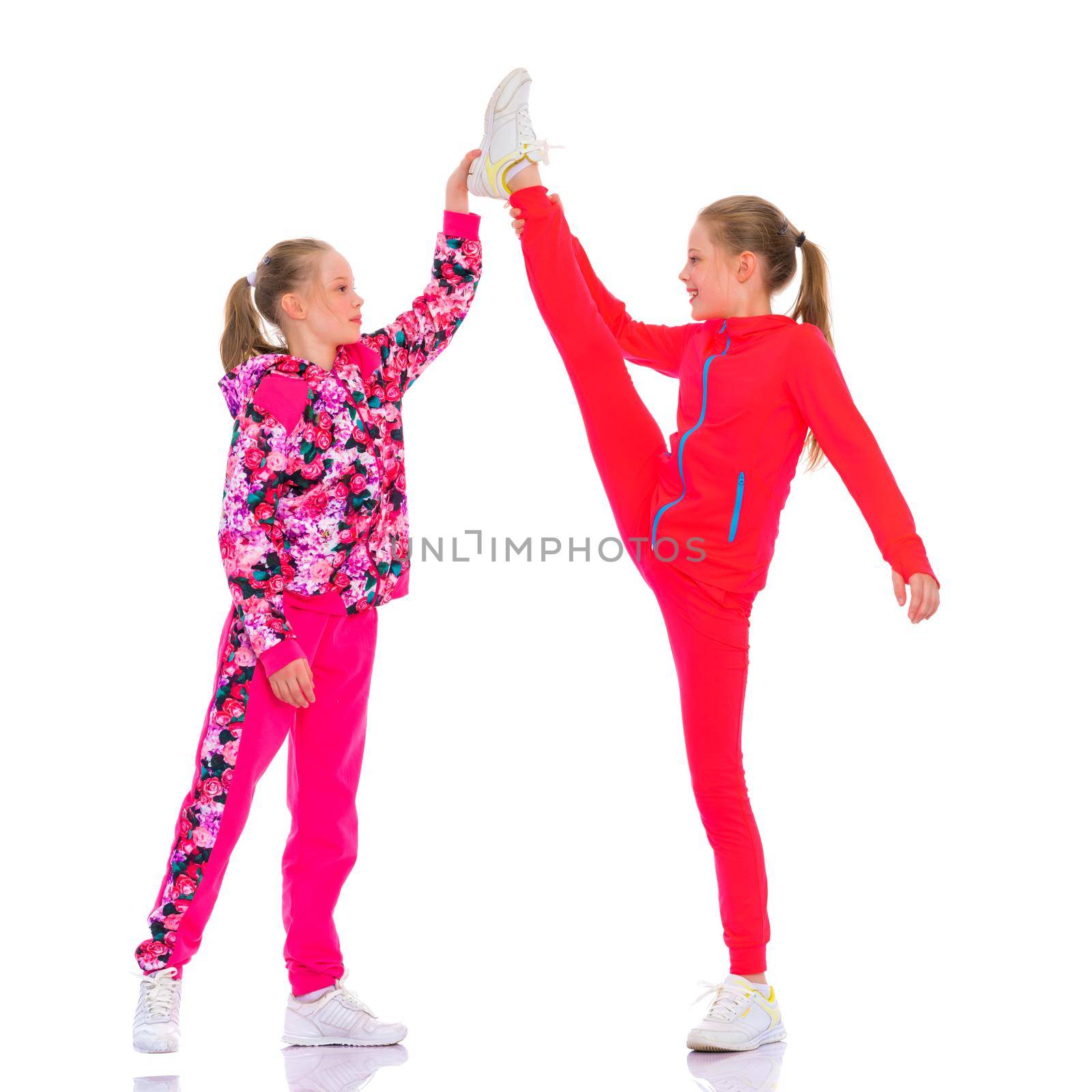 Girls gymnasts together make a twine. The concept of people, sport, fitness, healthy lifestyle. Isolated on white background.