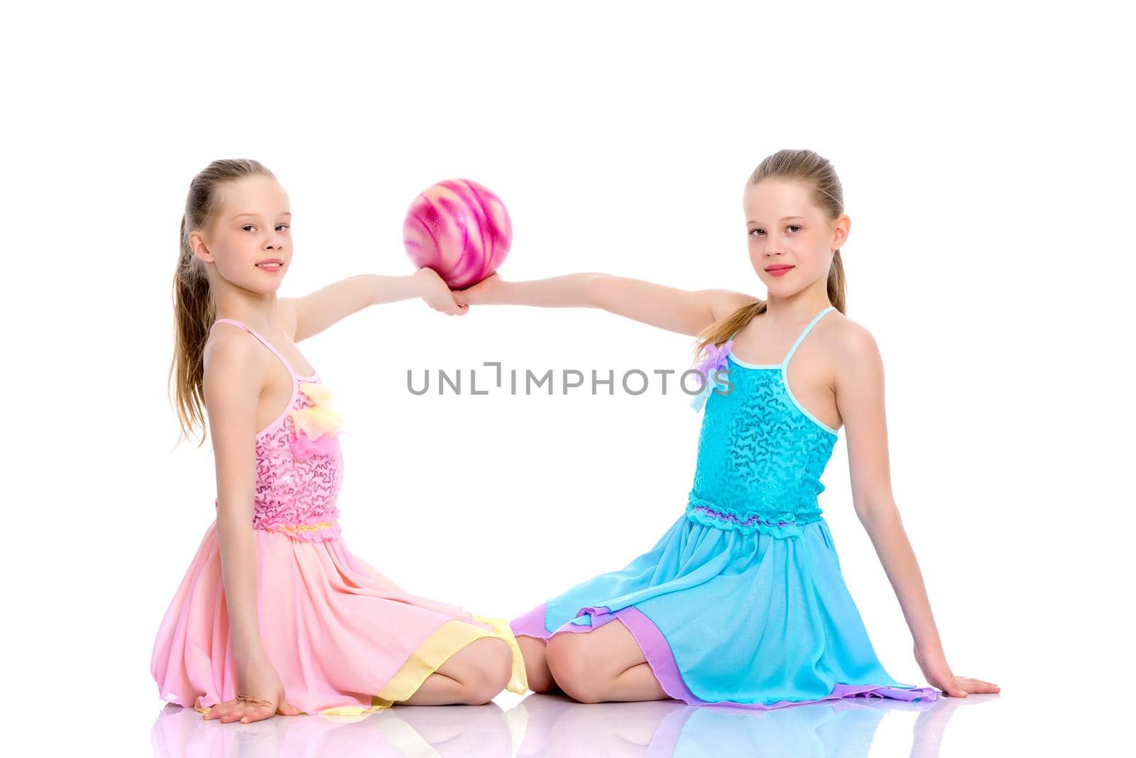 Girls gymnasts perform exercises with the ball. by kolesnikov_studio
