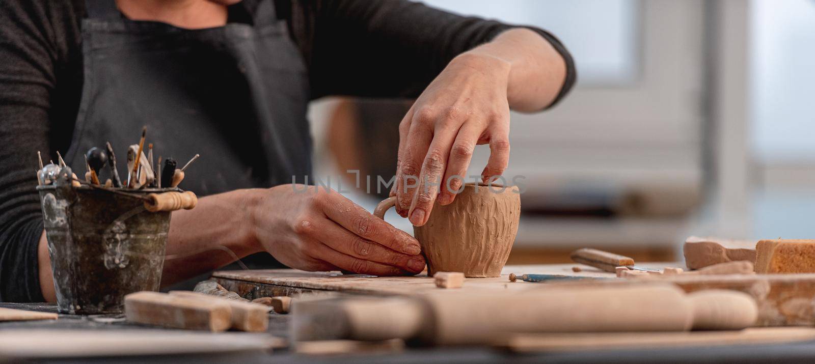 Hands of potter forming cup from clay by tan4ikk1