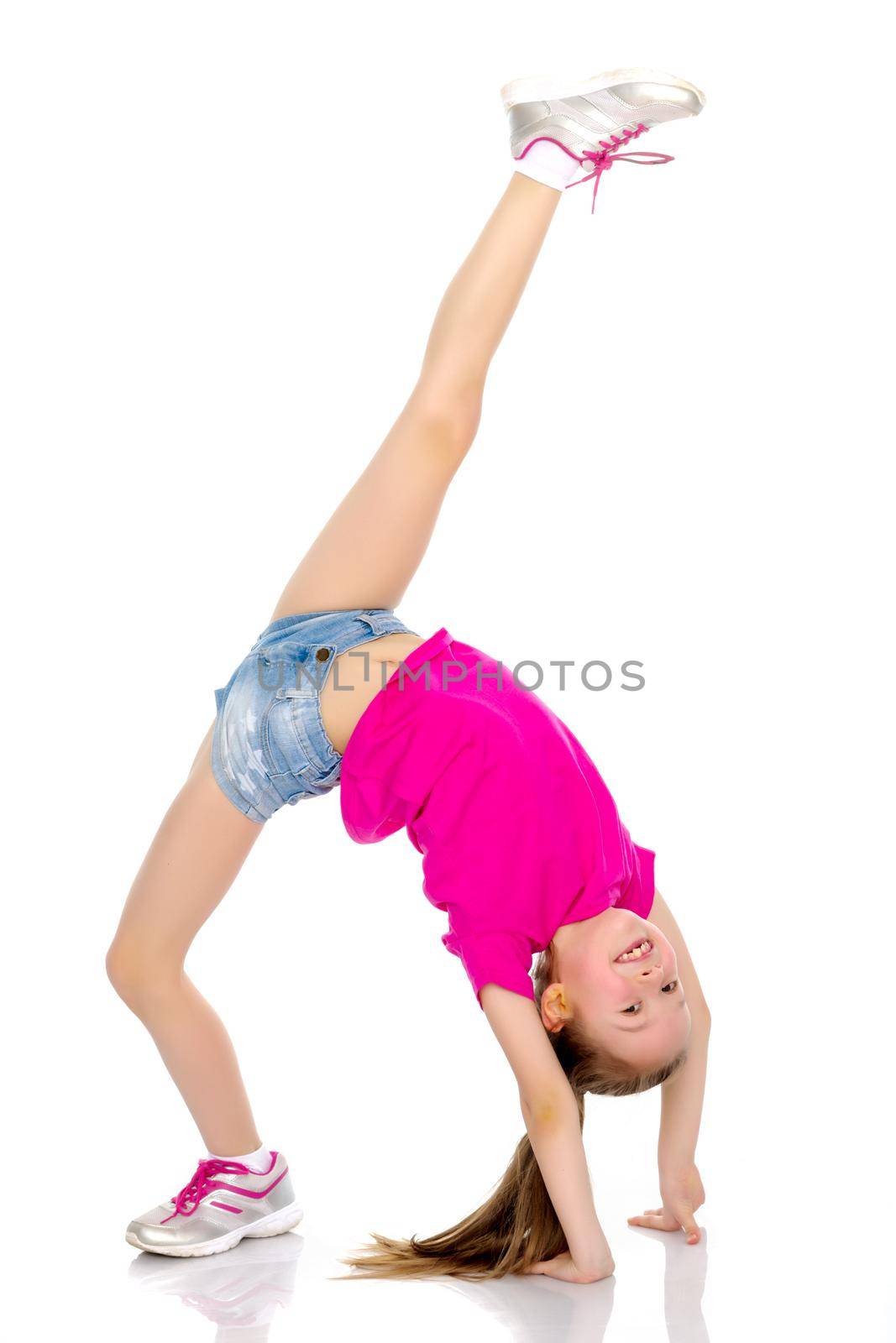 Girl gymnast performs a bridge with a raised leg. The concept of a healthy lifestyle, sport. Isolated on white background.