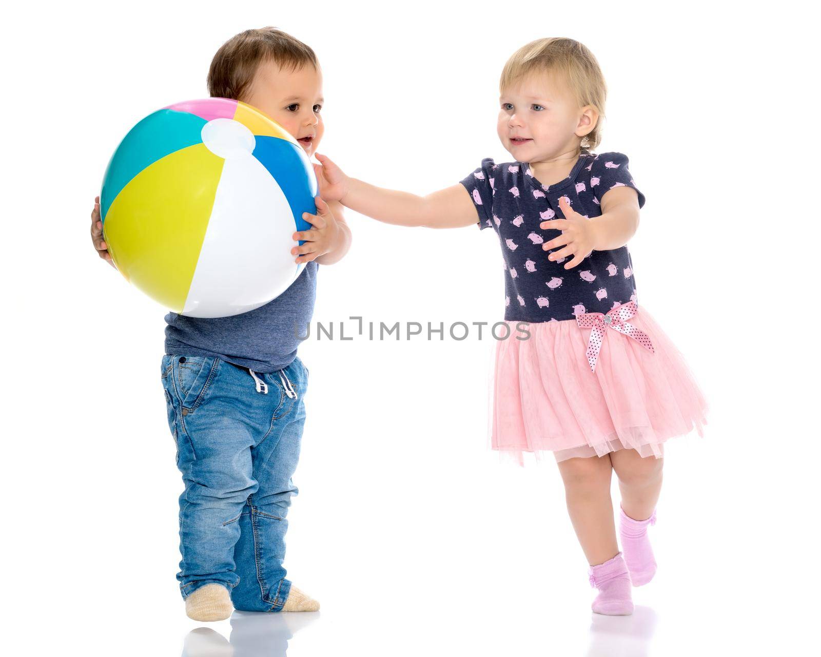 Toddler boy and girl playing with ball. by kolesnikov_studio