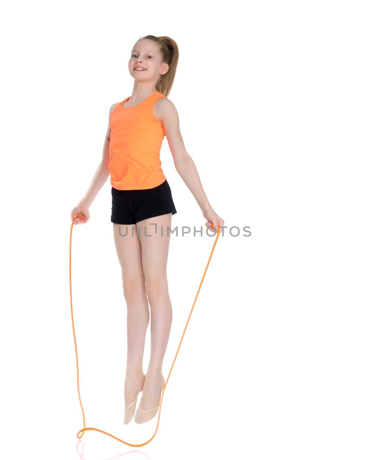 A girl gymnast performs exercises with a skipping rope. The concept of a healthy lifestyle, sports education of a child, Happy childhood. Isolated on white background.