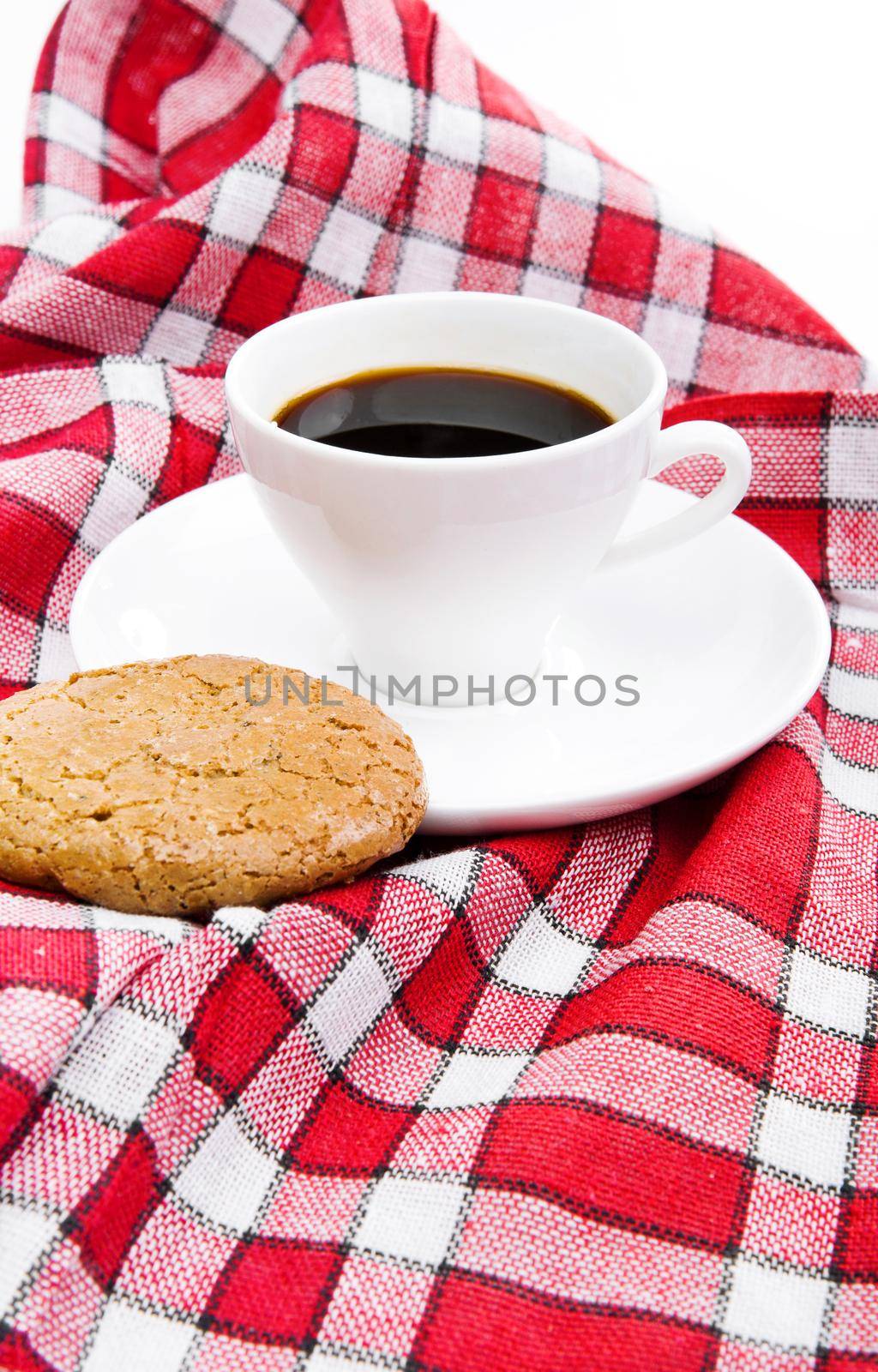 cup of tea and cookie on a red tablecloth