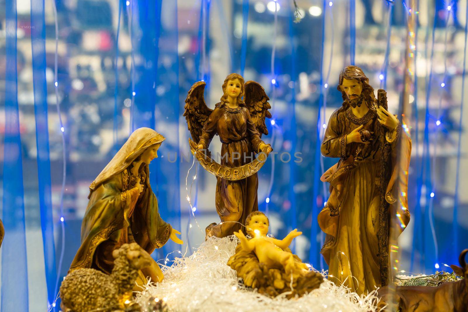 Christmas nativity scene photograph of Mary, a king, a shepherd and lamb worshipping baby Jesus.