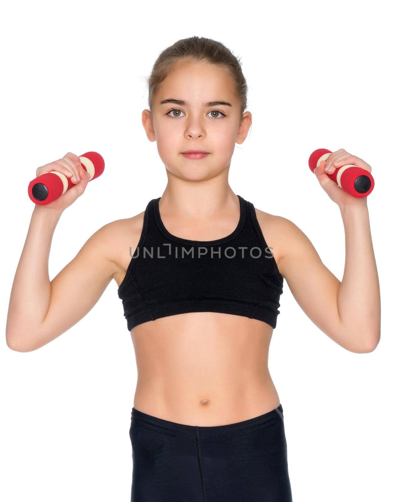 A cute little girl doing exercises with dumbbells. The concept of strength, health and sport. Isolated on white background.