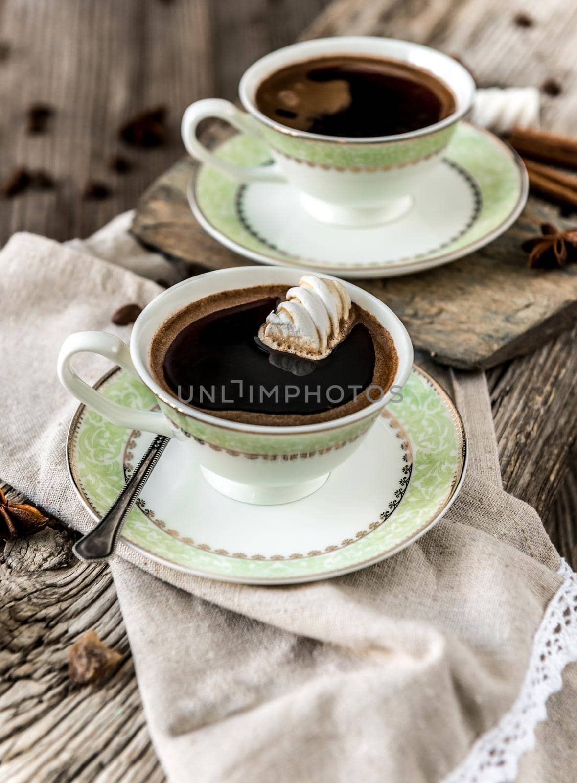 two cups of black coffee on an old wooden background