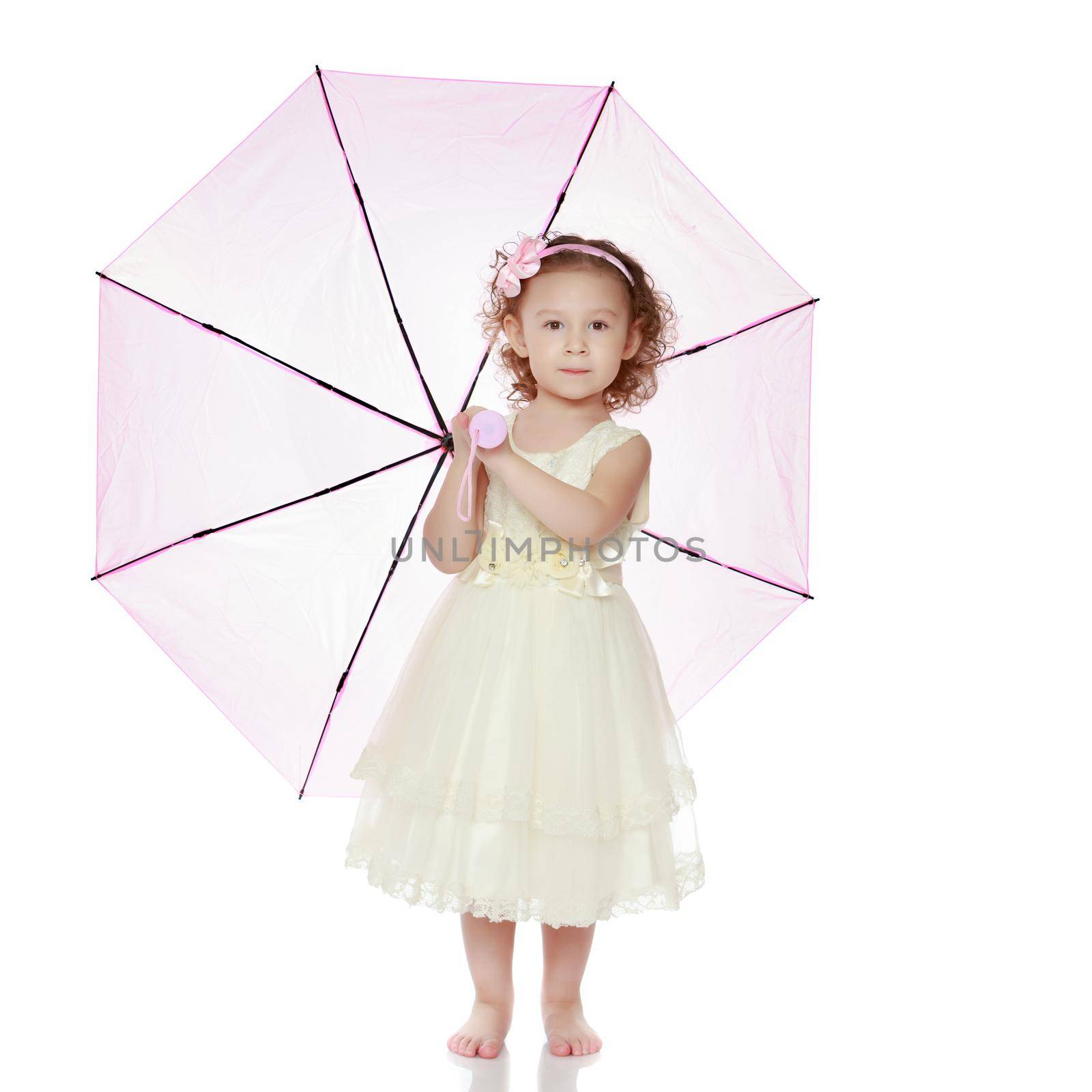 A nice little girl hid under an umbrella. The concept of a happy childhood, outdoor recreation, protection from bad weather. Isolated on white background.