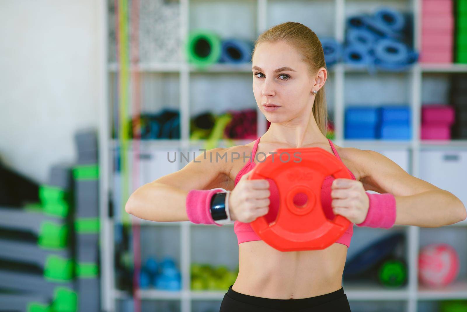 Woman with dumbbell fit slim abs body isolated on a white background. Healthy lifestyle.