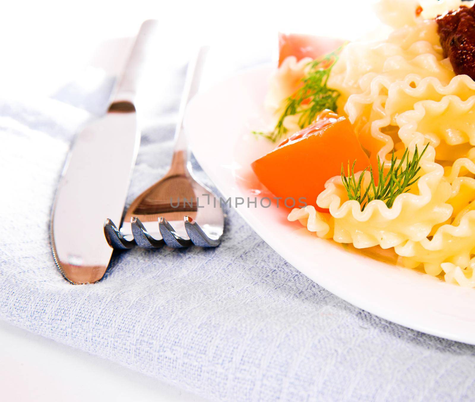 Pasta with fresh tomatoes ower white background