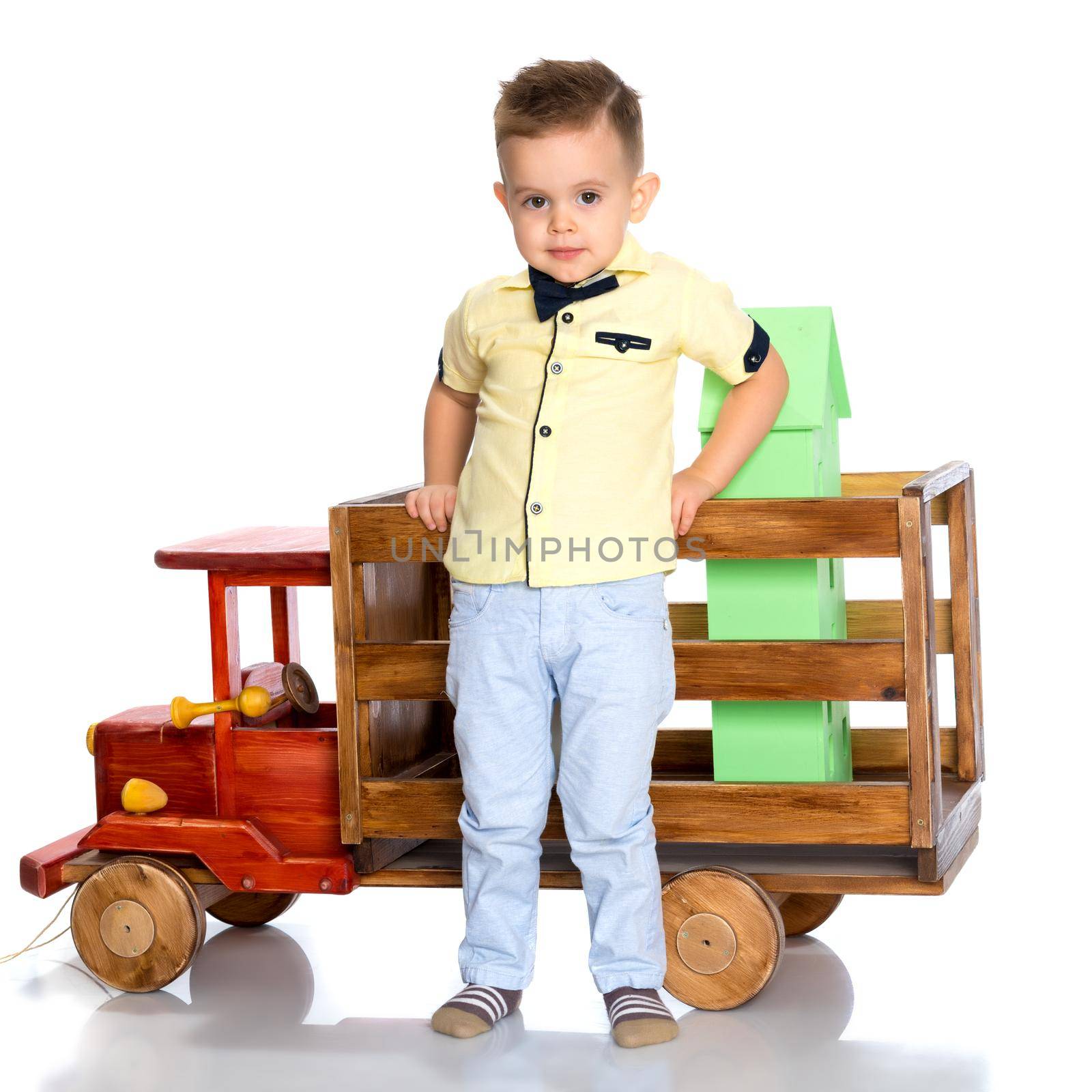 A little boy is playing with a toy car. by kolesnikov_studio