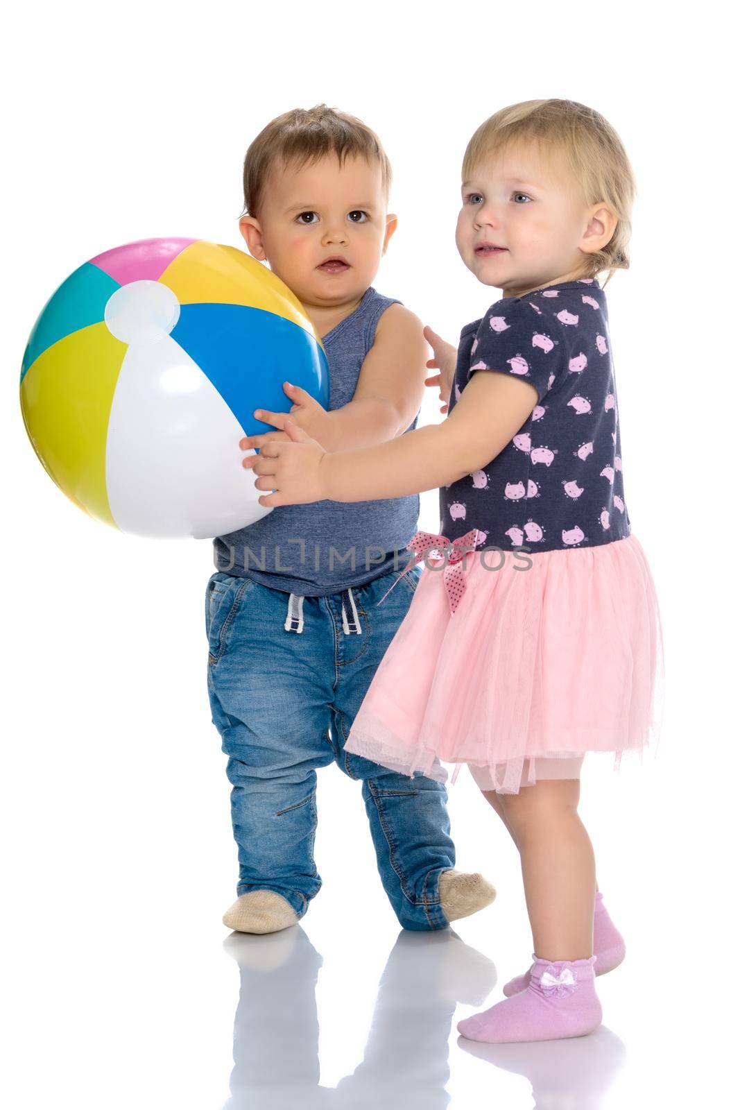 Toddler boy and girl playing with ball. by kolesnikov_studio