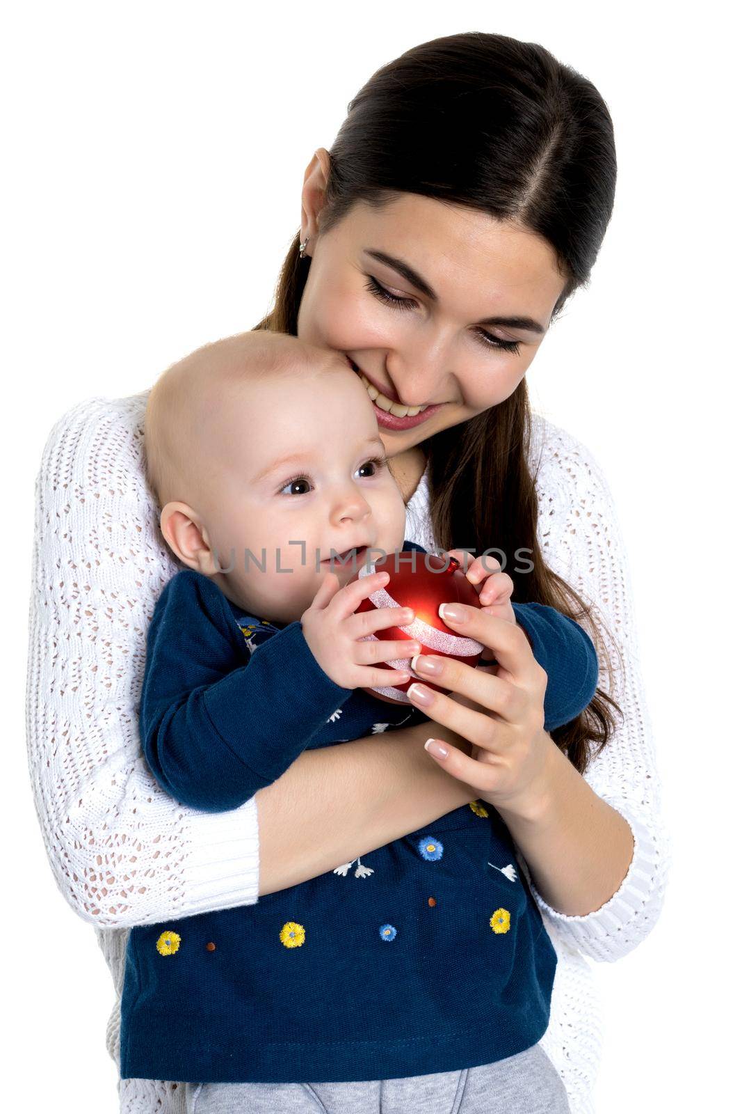 A happy mother is holding a small daughter with a Christmas tree by kolesnikov_studio