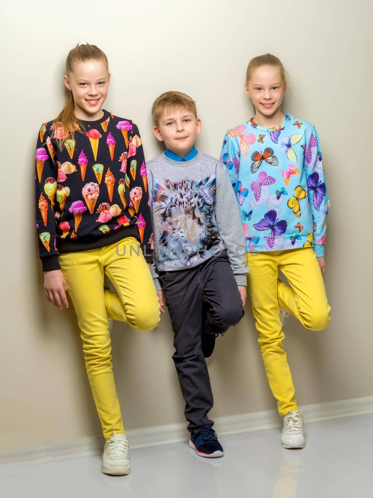 Group of happy little children posing in studio. The concept of a happy childhood, friendship.