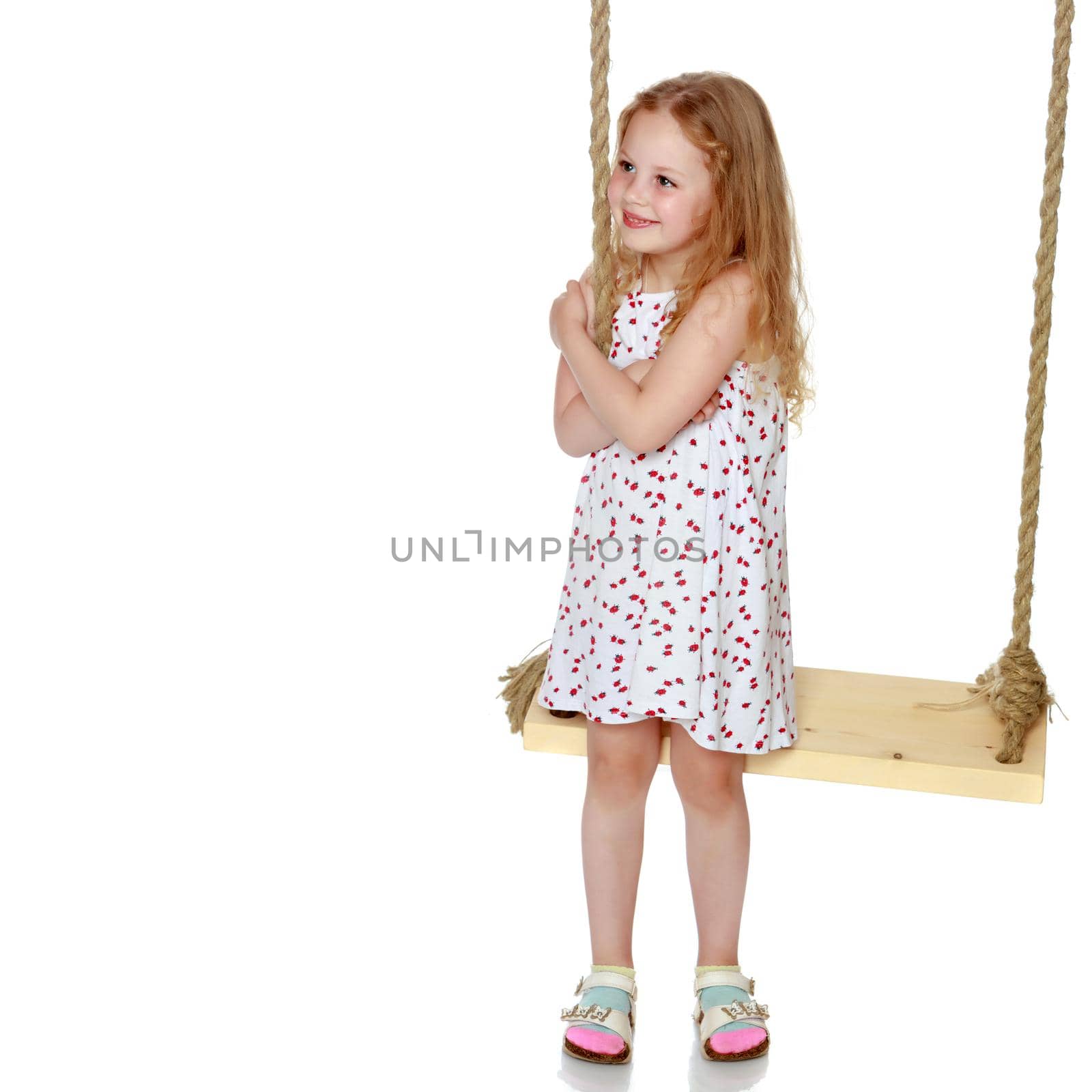 Little girl swinging on a swing by kolesnikov_studio