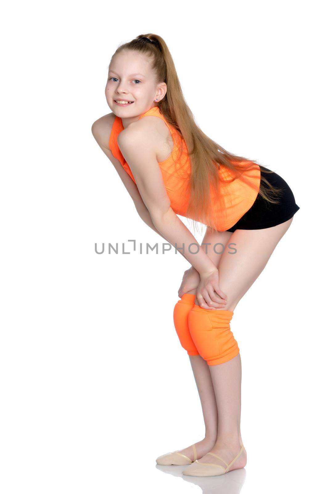 A teenage girl is engaged in fitness. She performs various exercises. The concept of childhood, sport, a healthy lifestyle, physical development of personality. Isolated on white background.