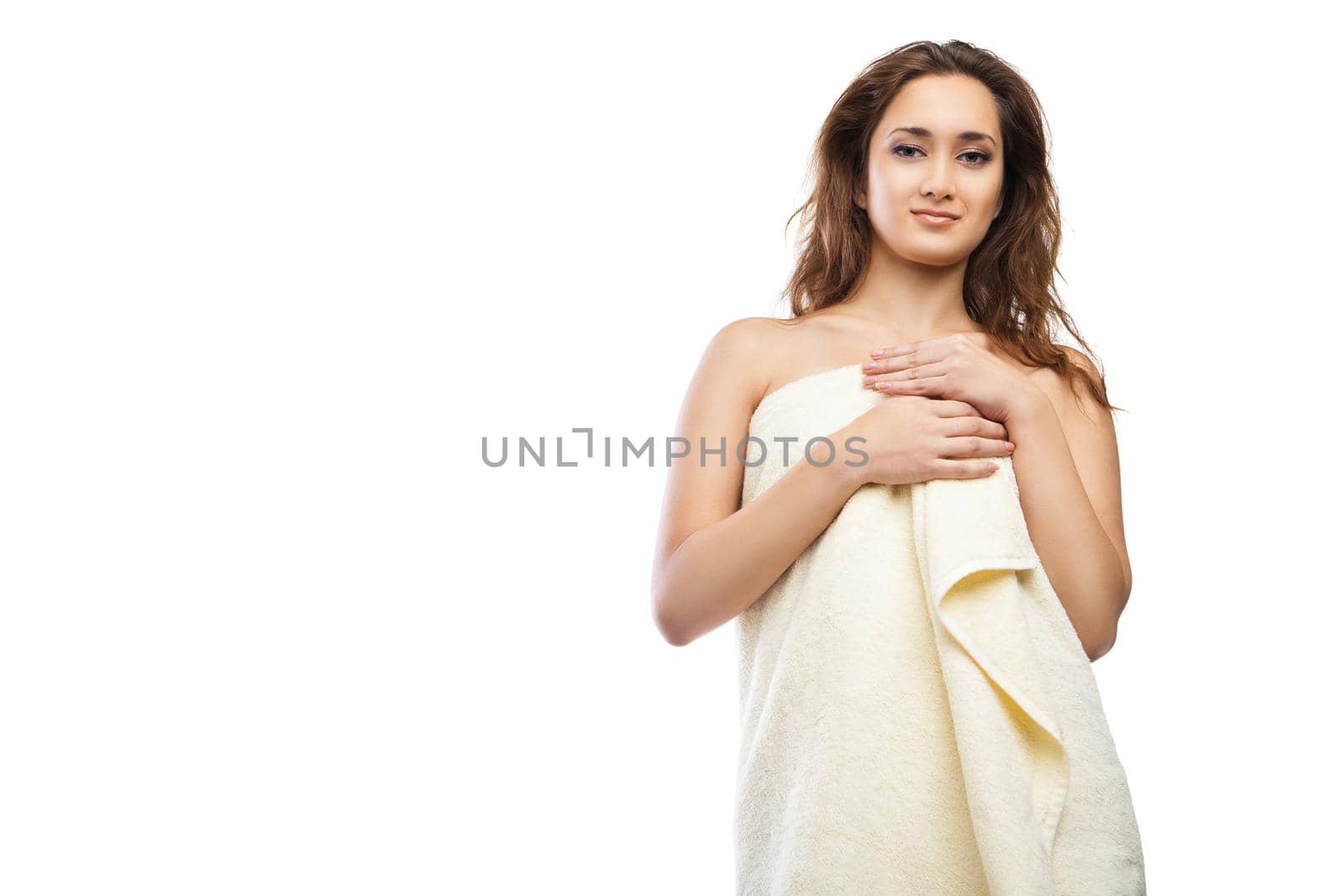 portrait of young beautiful woman wrapped in towel after bath. Spa. Isolated over white background