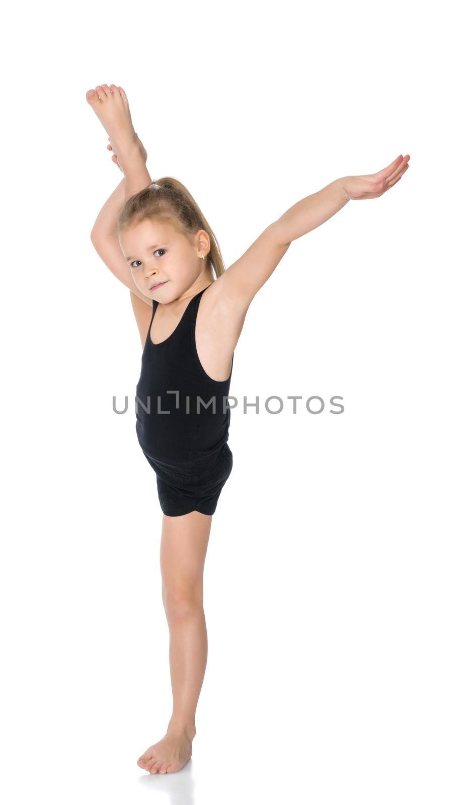 A girl gymnast balances on one leg.The concept of childhood, sport, a healthy lifestyle. Isolated on white background.