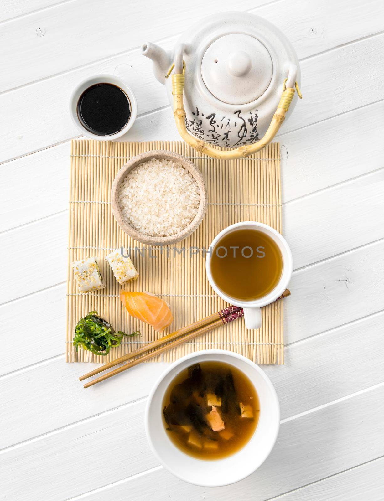 Asian food, rice and raw fish, soy sauce and some mushroom soup, topview