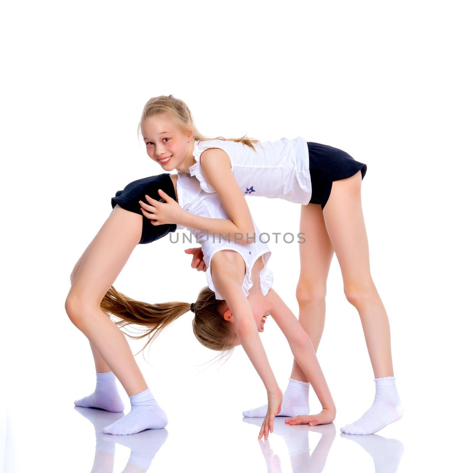 Girls gymnasts perform exercises. The concept of strength, health and sport. Isolated on white background.