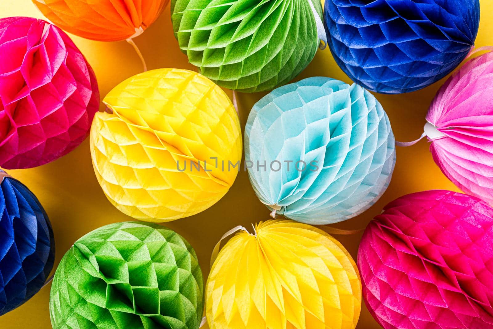 Festive background with colorful paper balls. Greeting card concept voor birthday, party, invitation, carnival. Top view, flat lay.