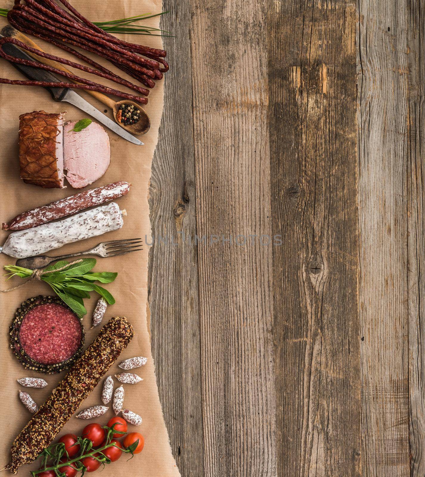 Assortment of cold meats over wooden background with space for text