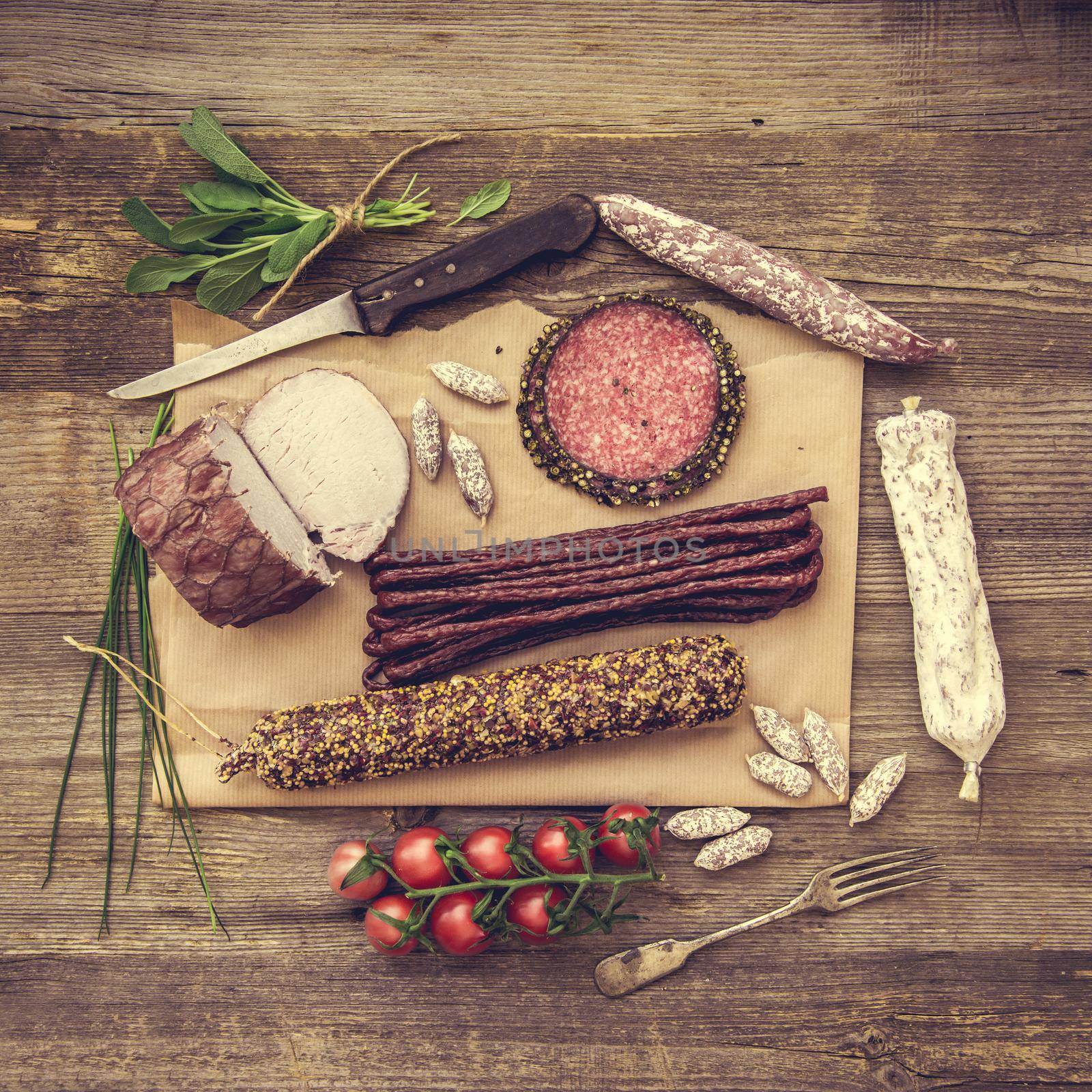 Assortment of cold meats over wooden background
