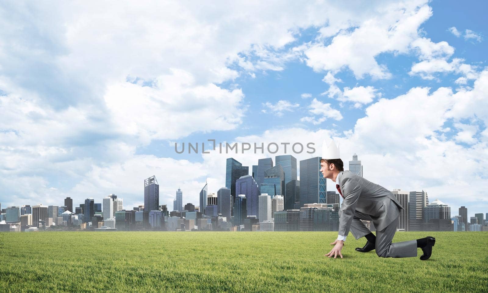 Young handsome businessman wearing white paper crown running in a hurry