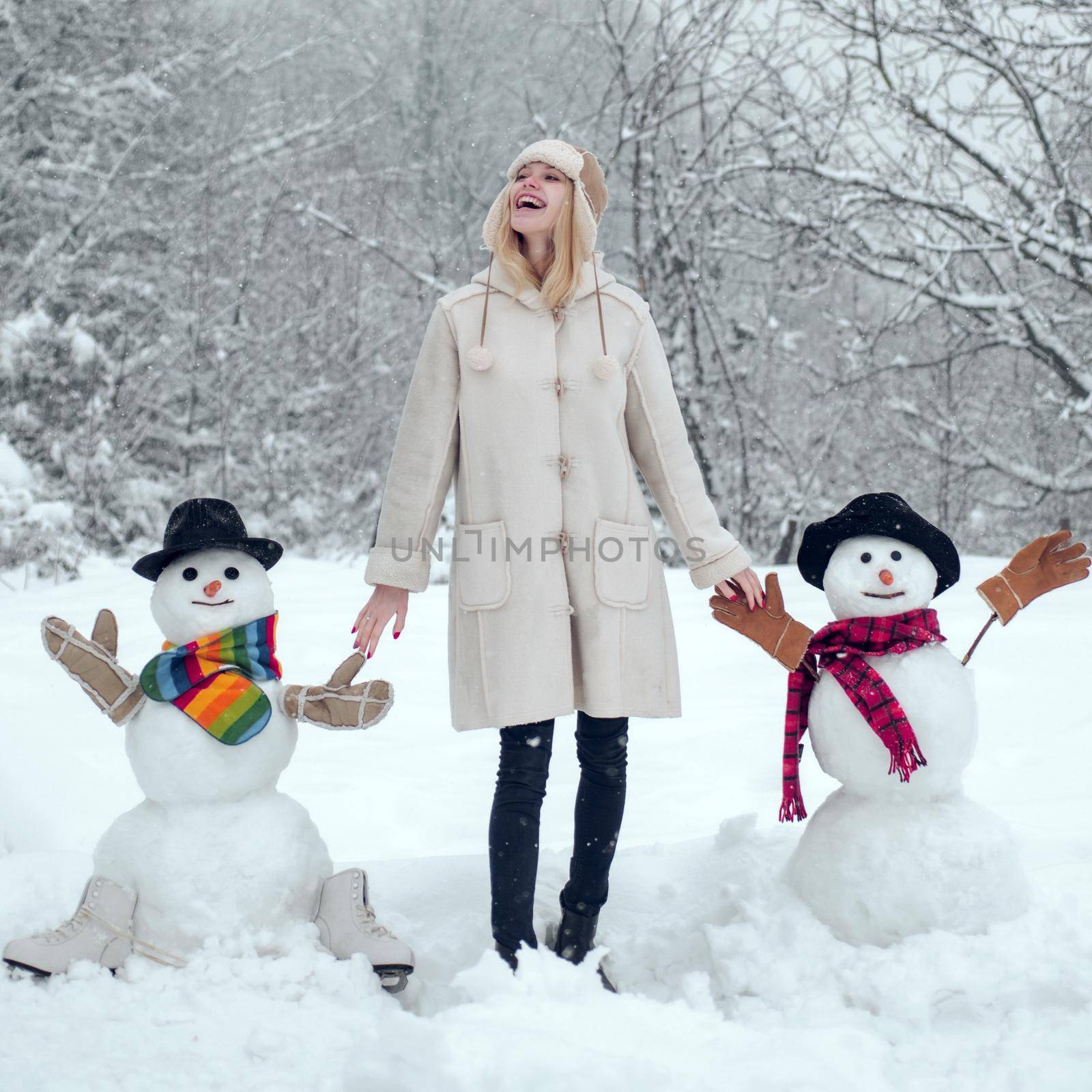 Winter woman. Snowing winter beauty fashion concept. Winter portrait of young beautiful woman in snow Garden. by Tverdokhlib