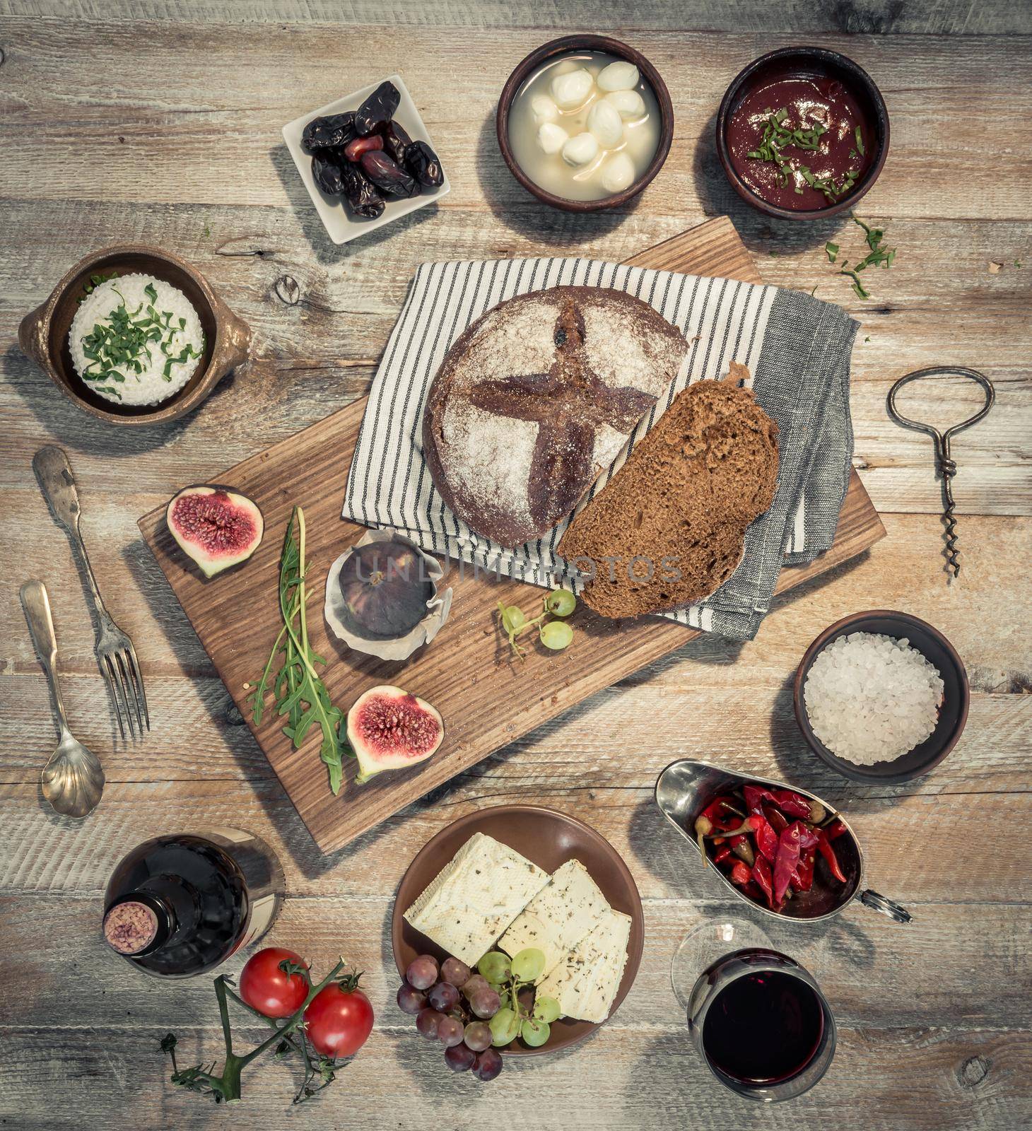 wine with vegetables, fruits and cheeses with bred on wooden table top view