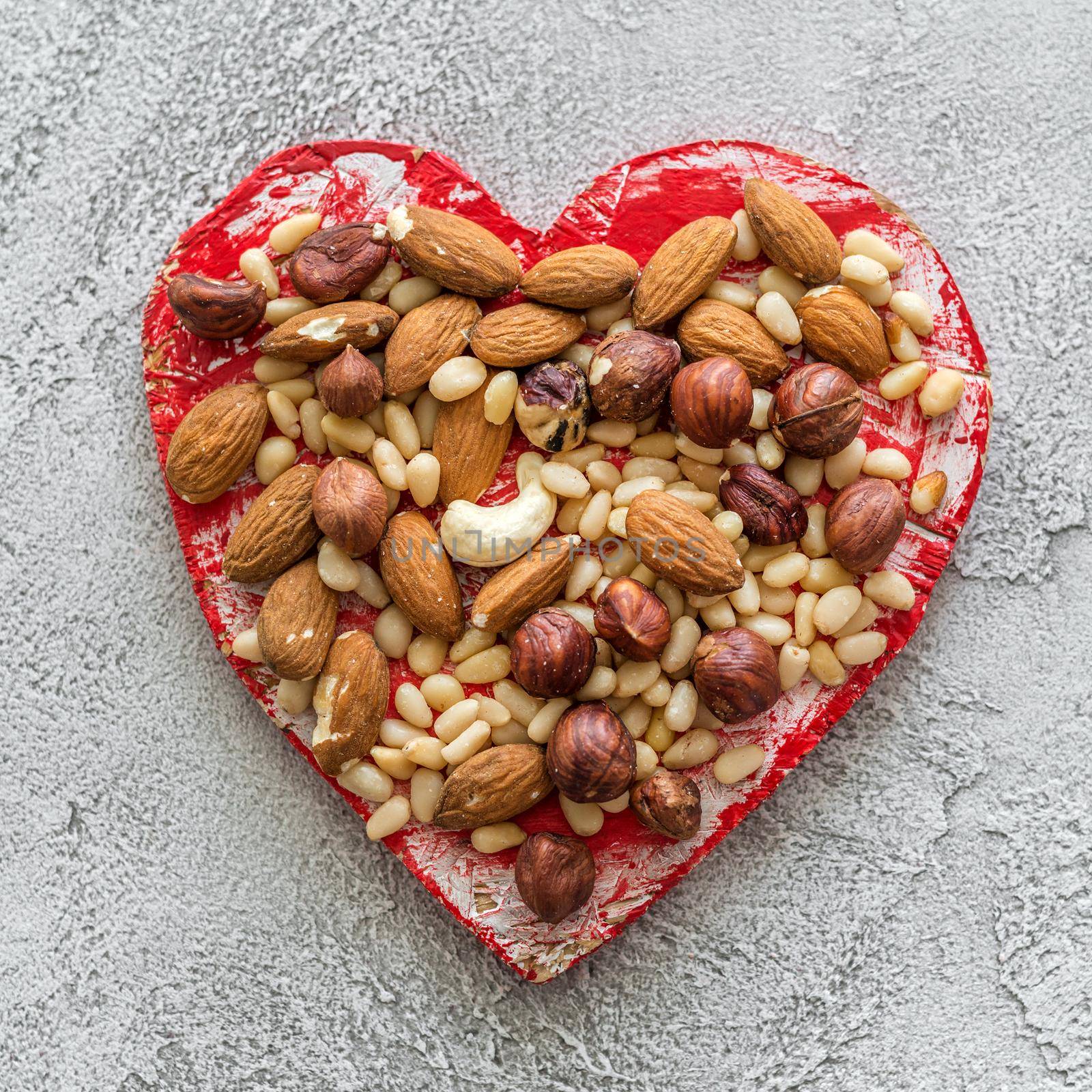 heart with nuts on a gray background. Healthy food concept