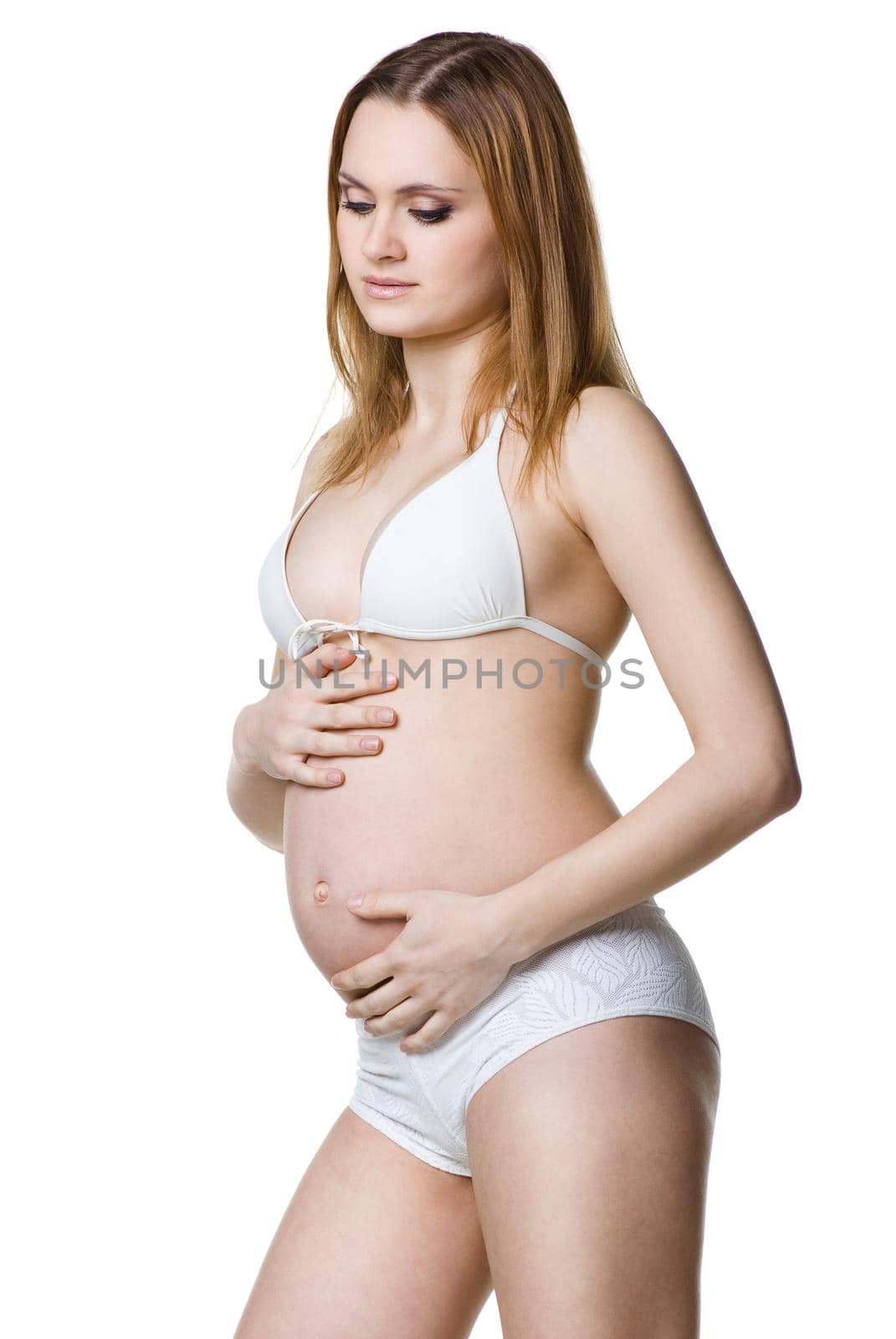 portrait of the beautiful pregnant woman posing isolated on white
