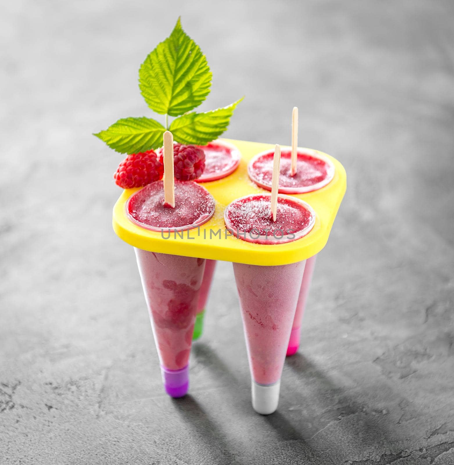 homemade raspberry cones standing in yellow ice-cream container by tan4ikk1