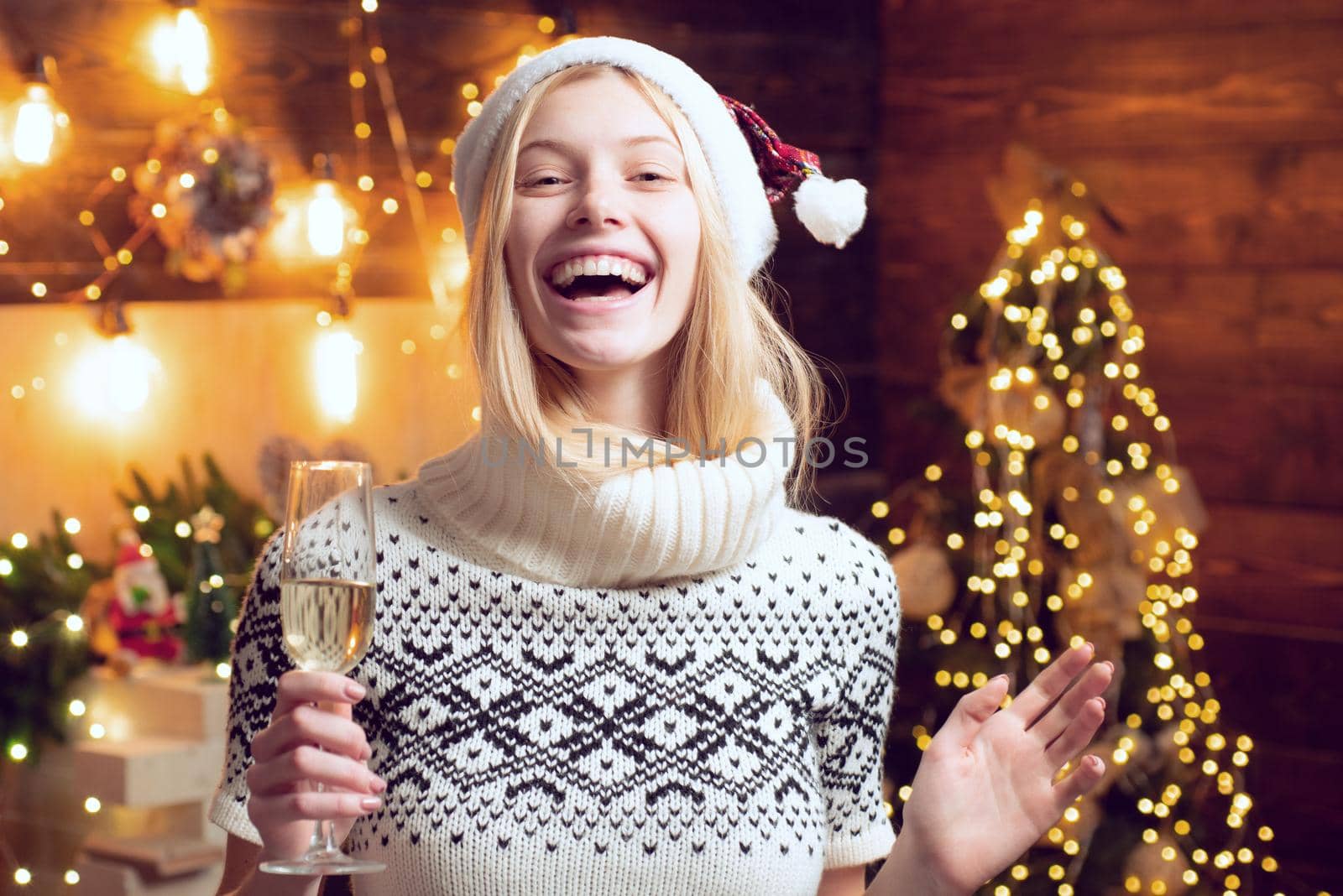 Woman cozy knitted sweater enjoy christmas atmosphere at home. Girl winter clothes santa claus hat celebrate christmas and happy new year