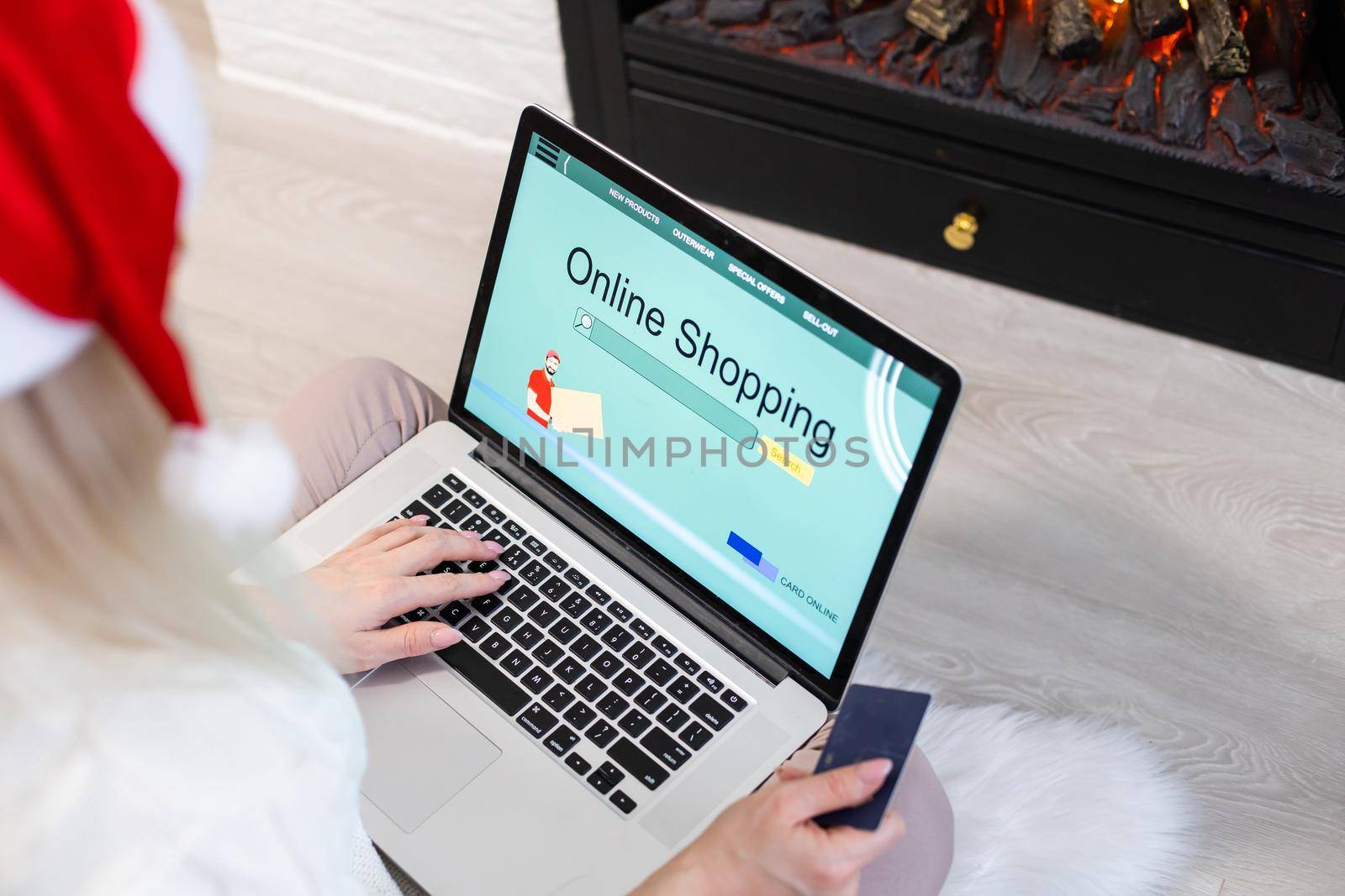 Christmas online shopping. Female buyer with laptop, copy space on screen. Woman buys presents, prepare to xmas eve, sitting among gifts boxes and packages. Winter holidays sales