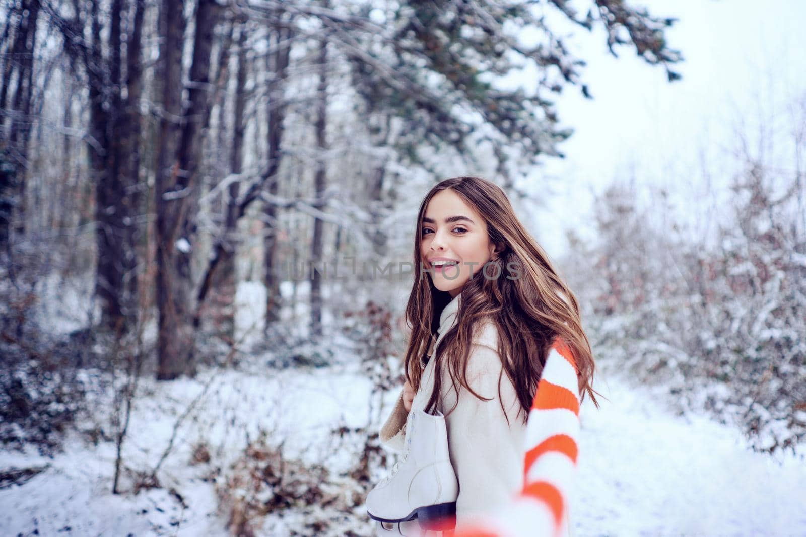 Winter woman. Outdoor close up portrait of young beautiful girl with long hair. Young woman winter portrait
