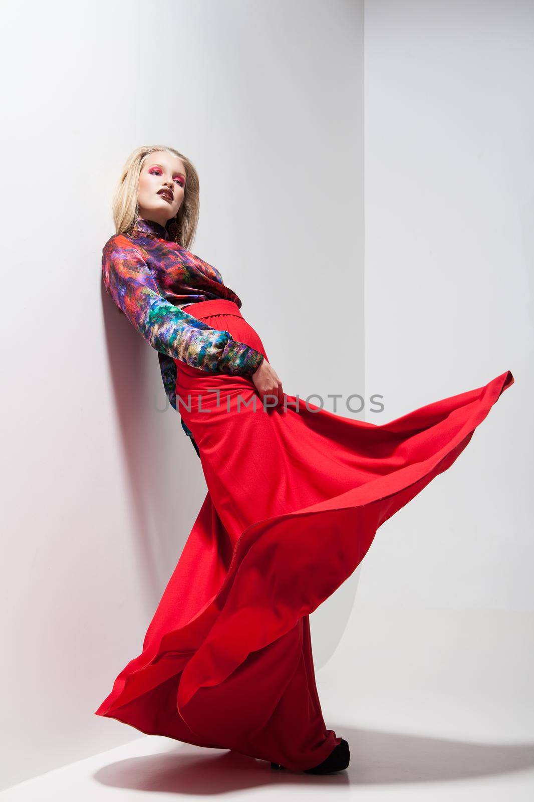 Fashion photo of young woman in red dress. Studio by Julenochek