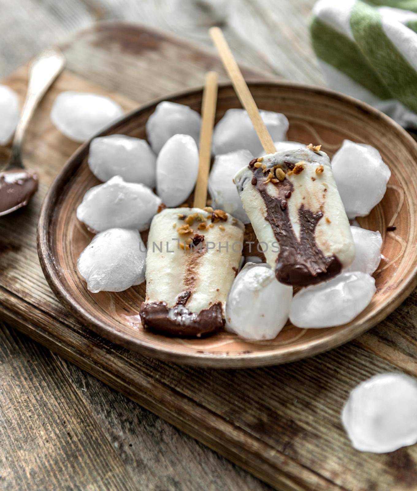 Homemade cream ice cream with chocolate and muesli on a wooden background