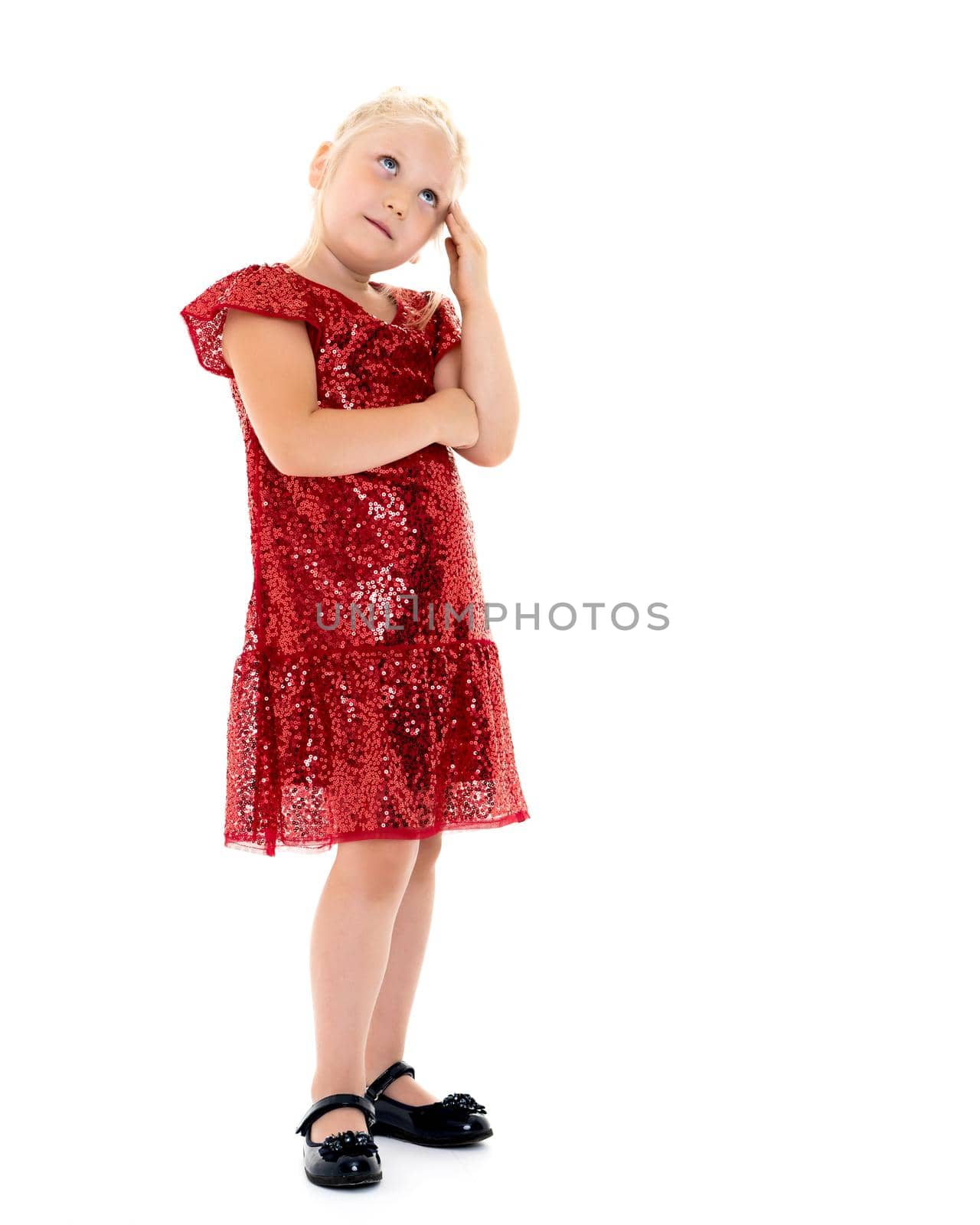 A nice little girl thinks. The concept of education and school, children's creativity. Isolated on white background.