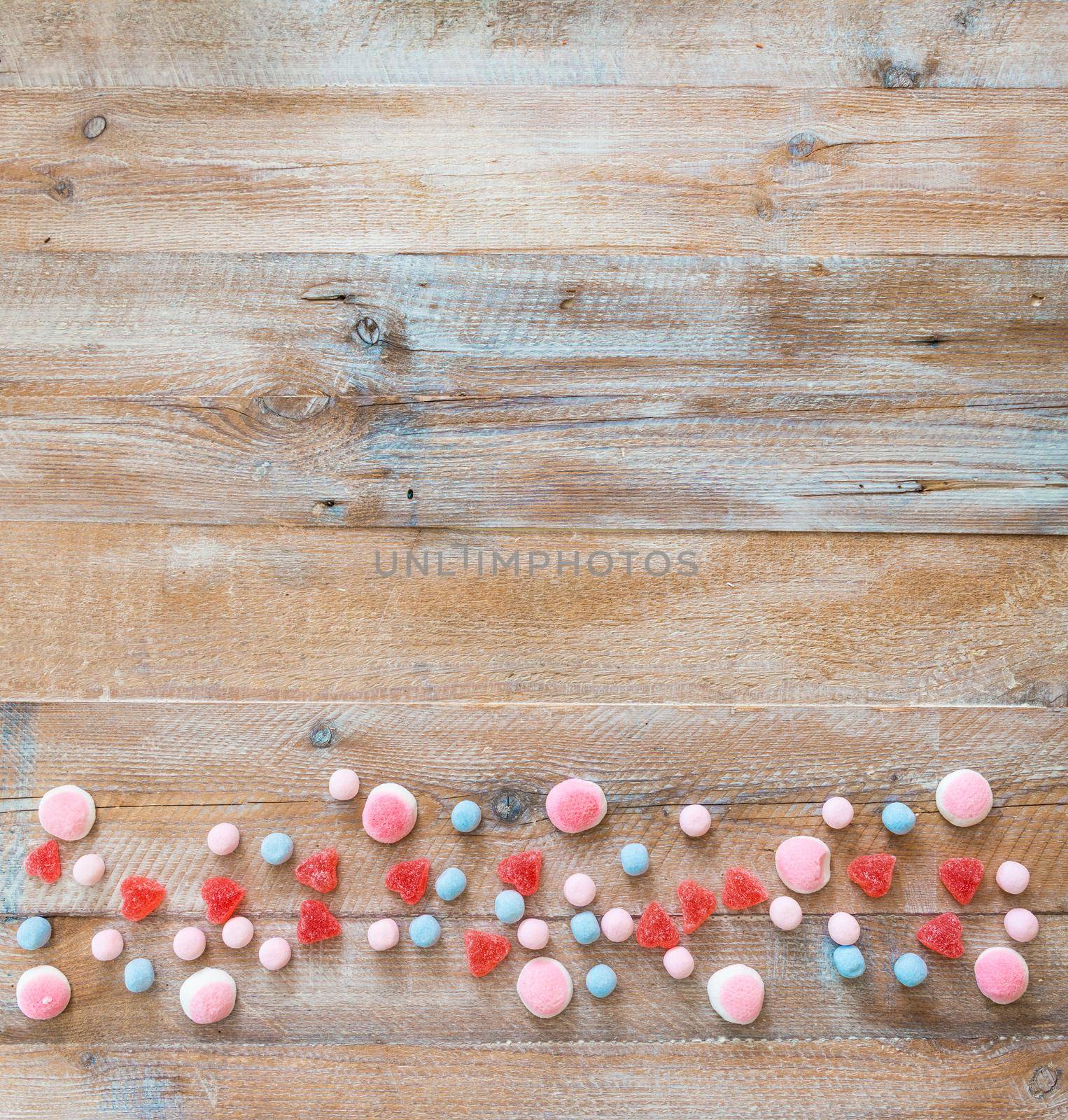 candy in the form of heart on wooden background
