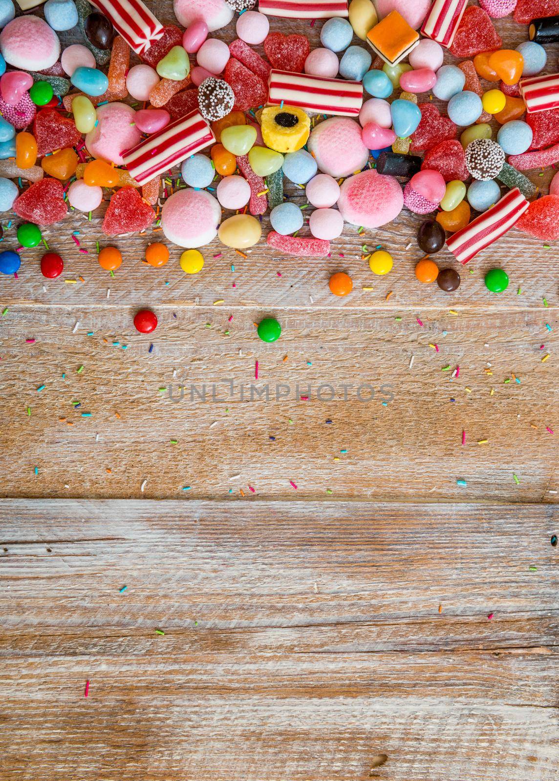 variety of candies on a wooden background by tan4ikk1