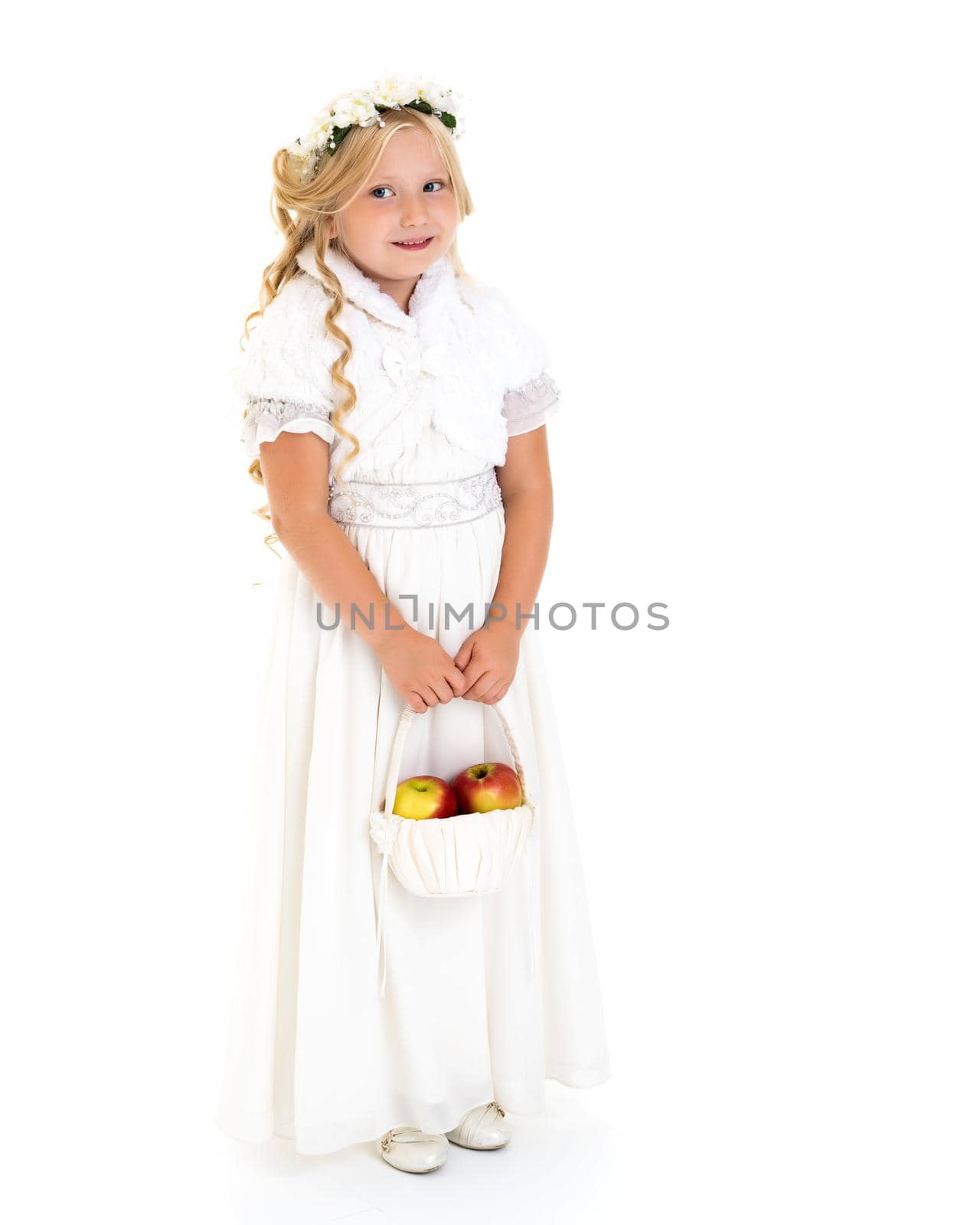 Little girl with a basket of apples. The concept of healthy eating, happy childhood. Isolated on white background.