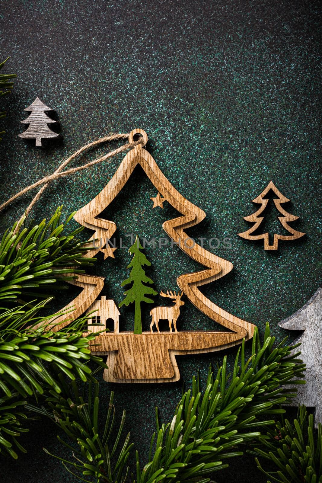 Festive background with wooden christmas tree and decoration. Copy space, winter holidays greeting card, flat lay, top view.