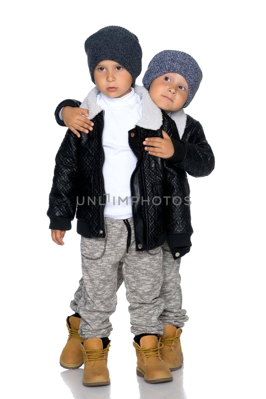 Two little boys in black jackets and hats. by kolesnikov_studio