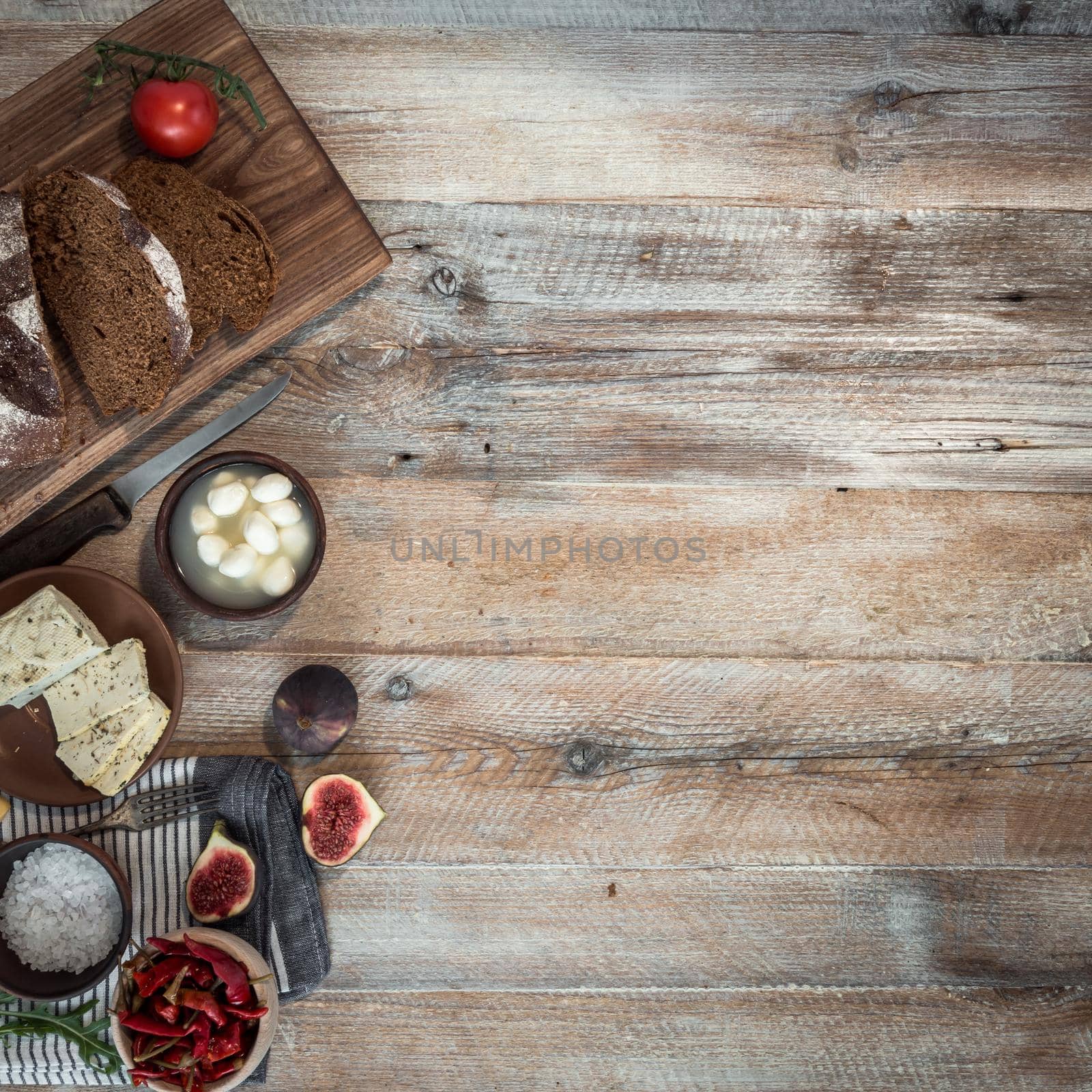 cheeses and brown bread on wooden table by tan4ikk1
