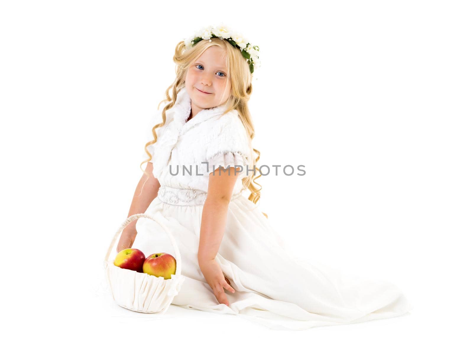 Little girl with a basket of apples. The concept of healthy eating, happy childhood. Isolated on white background.