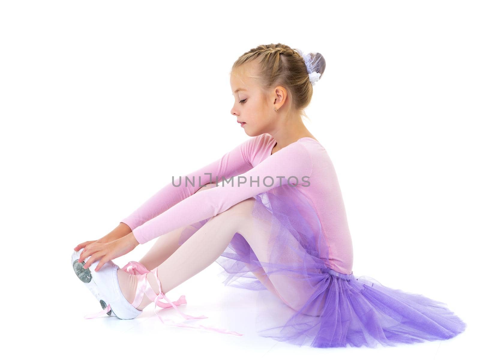 Little girl wears ballet shoes. by kolesnikov_studio
