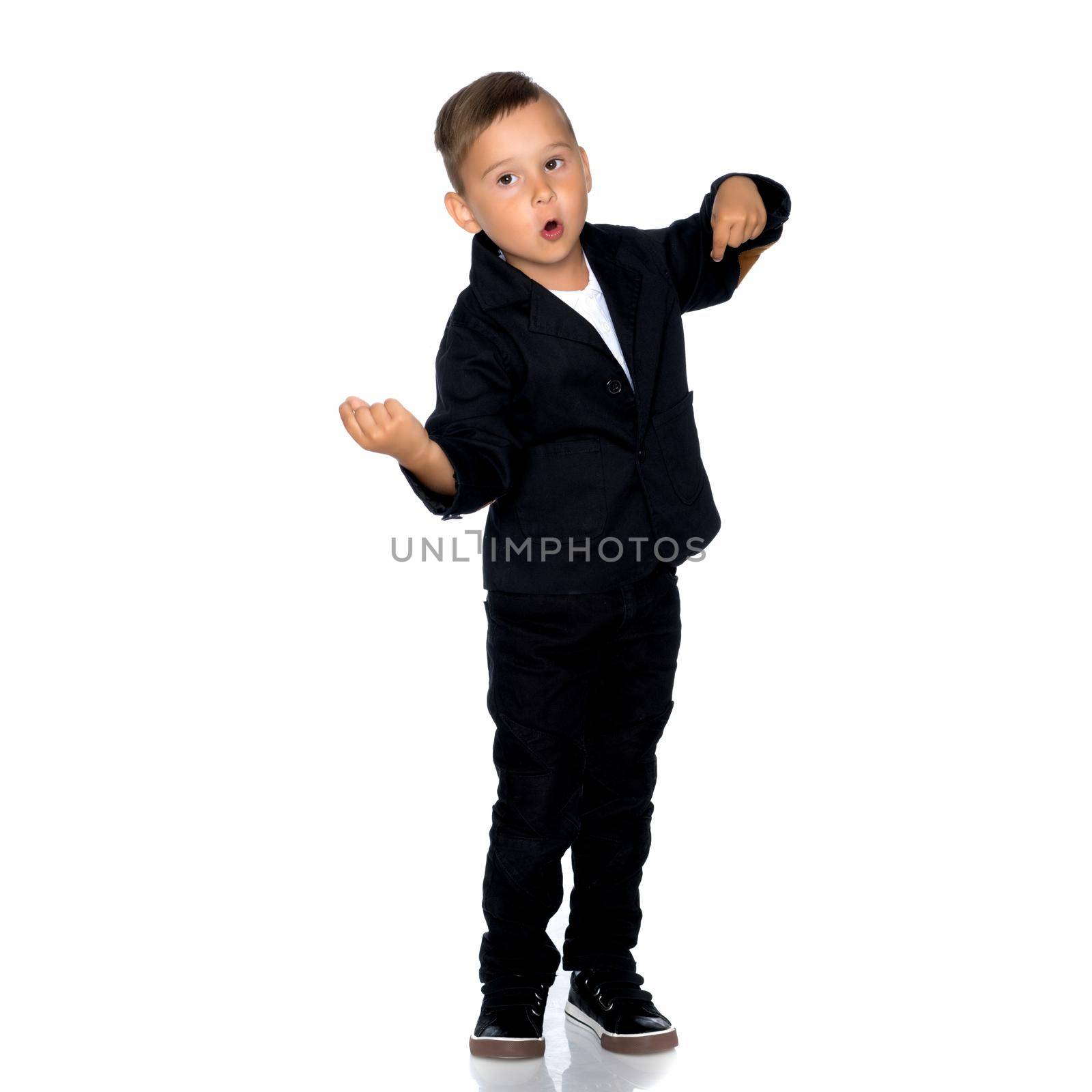 Little boy emotionally waving his hands in the studio on a white background. The concept of a happy childhood, family and people. Isolated.